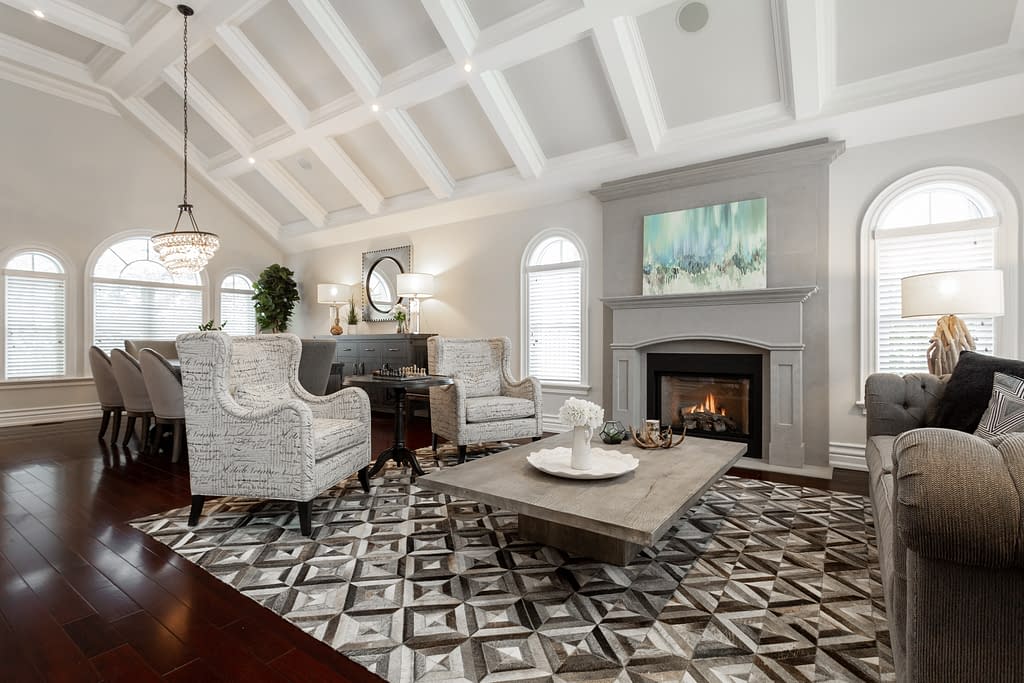 Real Estate 1 by Snapscene Photography Real Estate Photography of a luxury living room with tall vaulted ceiling and warm fire place
