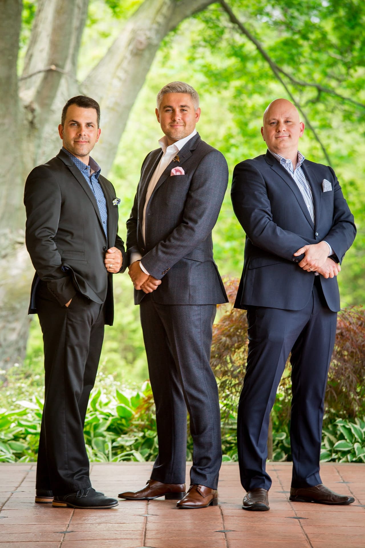 Group Portrait Group Photo of three real estate agents in front of trees and natural environment
