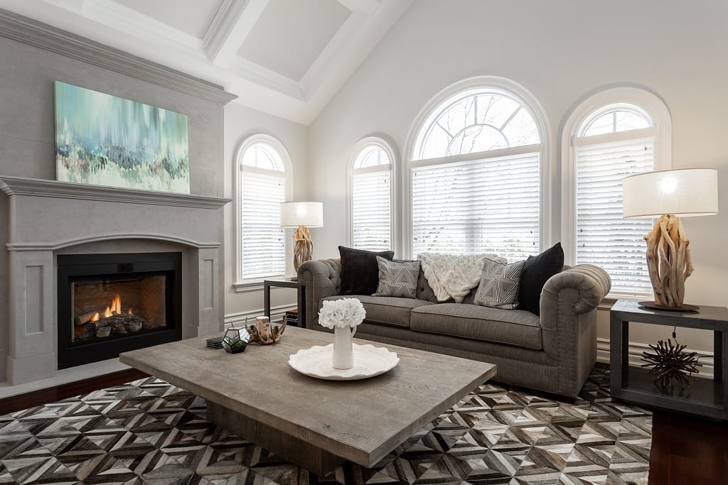 Real Estate 7 by Snapscene Photography luxury sitting area with vaulted ceilings, large windows and warm fire place