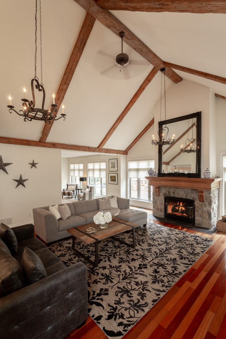 Tall vaulted ceiling in a rustic living room with fireplace and sitting area