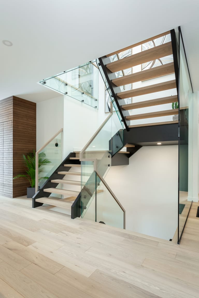 The modern oak and glass staircase at 414 Delaware Avenue